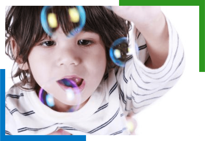 Young girl blowing bubbles with a smile.